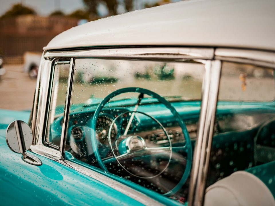 A blue car with a steering wheel and dashboard