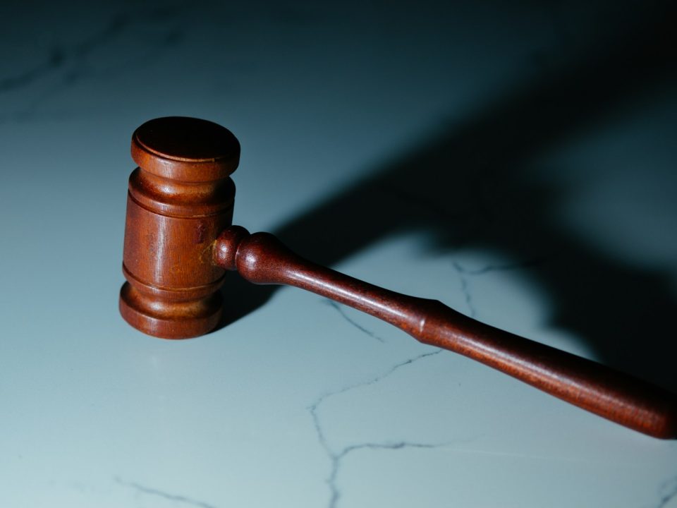 a wooden judge's hammer sitting on top of a table